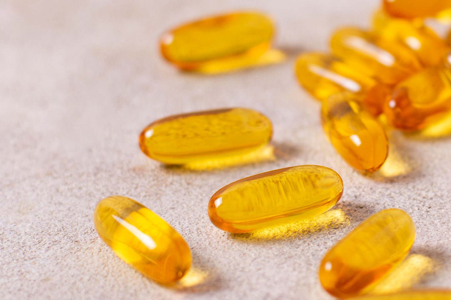 Yellow capsules on beige surface